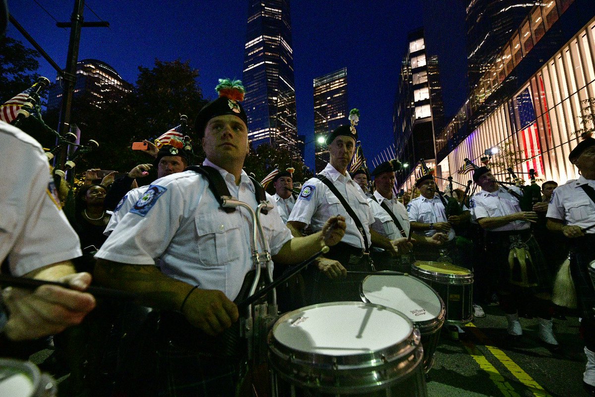 FDNY's tweet image. New Yorkers and visitors to our great city gather as the FDNY Emerald Society Pipes and Drums band honors those who made the Supreme Sacrifice 20 years ago at their annual sunset tribute at FDNY #Engine10 and #Ladder10 #NeverForget
