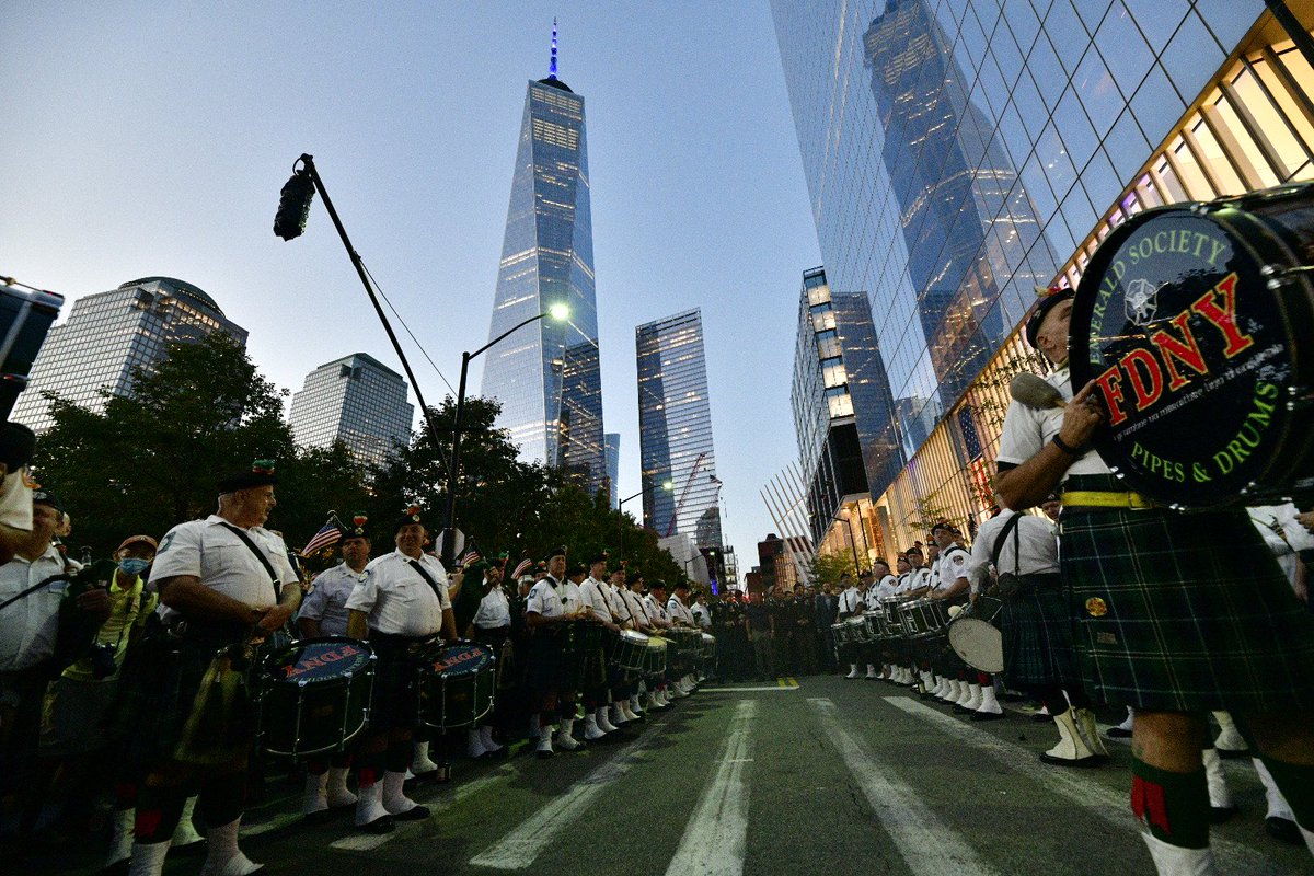 FDNY's tweet image. New Yorkers and visitors to our great city gather as the FDNY Emerald Society Pipes and Drums band honors those who made the Supreme Sacrifice 20 years ago at their annual sunset tribute at FDNY #Engine10 and #Ladder10 #NeverForget