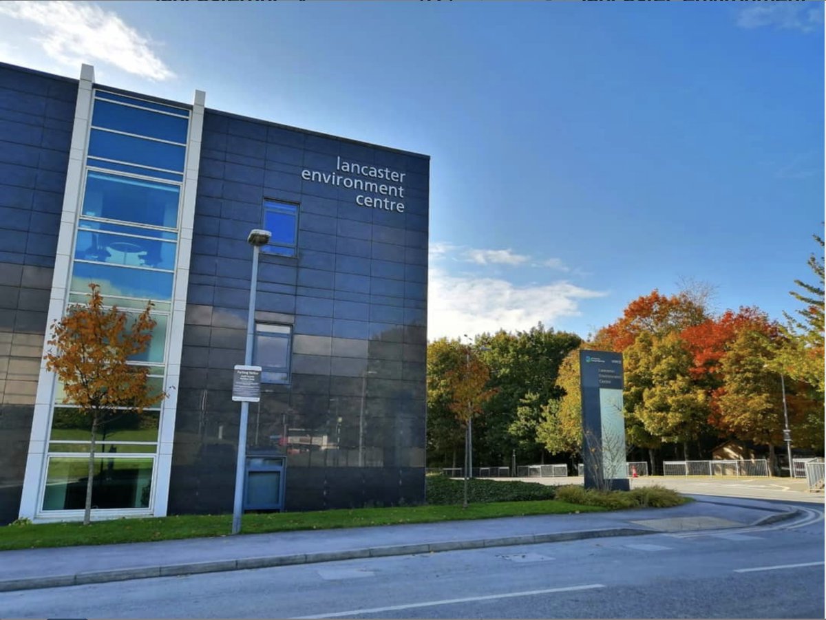 Lancaster Environment Centre against a blue sky with the leaves turning autumnal