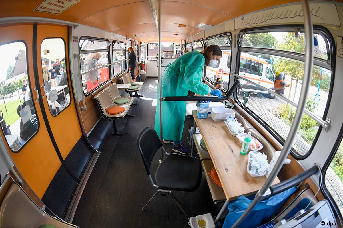 A medical worker prepares vaccinations in a train carriage in Wuppertal