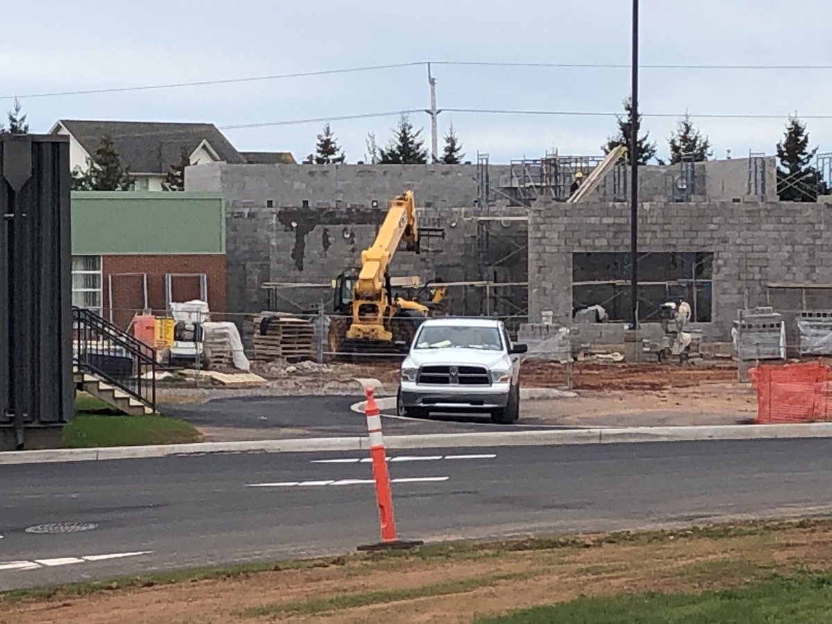 About 20 cars outside West Royalty Elementary today. Staff going in at intervals. School is closed for a week due to new COVID cases. Construction of new wing continues.