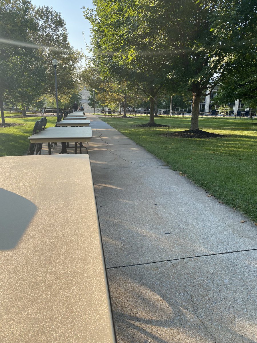 A row of tables line the sidewalk crossing Kuhlman Court.