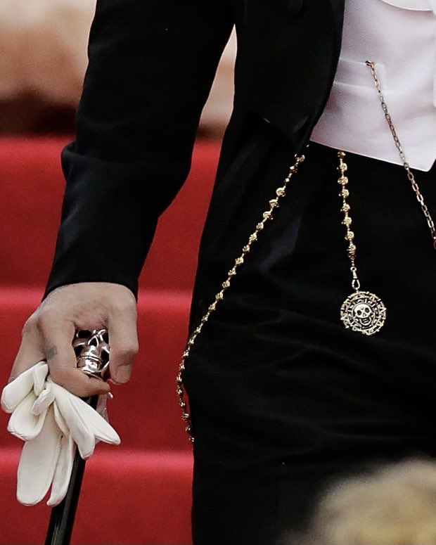 only johnny depp would use the pirates of the caribbean aztec gold coin as an accessory at the met gala