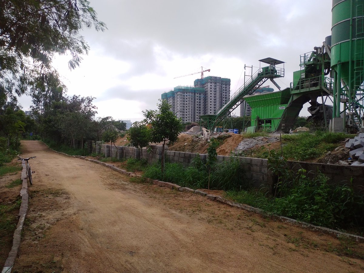 SudiptRoy's tweet photo. A huge stone crushing &amp; RMC plan for a construction right next to Palapitta Cycling Park is polluting the track. It's no longer a fun. Must have adequate barrier to keep the dust and pollution out. 
@KTRTRS @CitizensForHyd @HydWatch @Cykul_ #Hyderabad https://t.co/G9SnUaZIXc