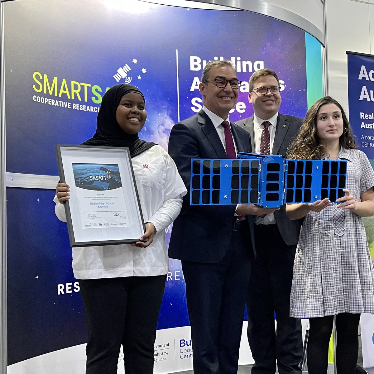 SASIC_Aus's tweet image. Premier @marshall_steven and @JohnGardnerMP, Minister for Education are here with students from Findon High School who have just been announced as winners of the #SASAT1 Naming Competition for their submission to name the 1st state satellite: Kanyini! 🛰  #AUSpaceForum @APY_Lands