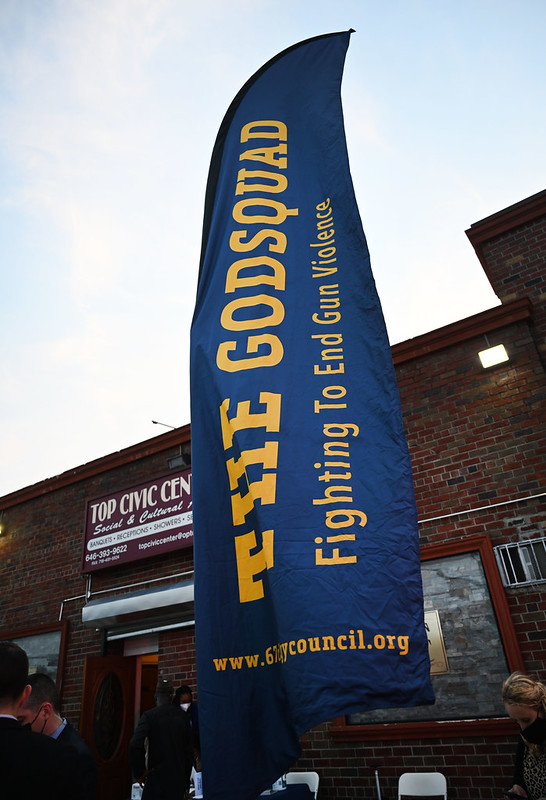 Outdoor flag reading "The GodSquad Fighting to End Gun Violence"