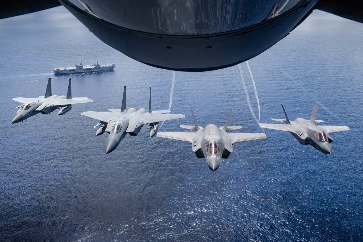 theF35JPO's tweet photo. . @USMC F-35B Lightning โก IIs & @USAF F-15 Eagles fly over U.K. aircraft carrier @HMSQNLZ, during #LSGE21. #F35Unites https://t.co/g8kwnXn9rr