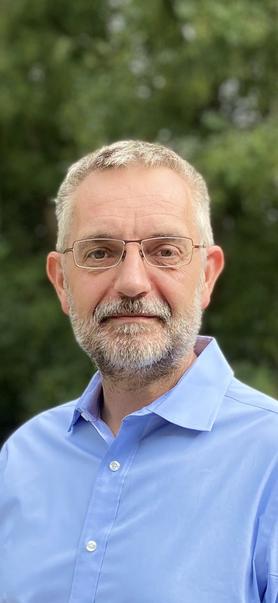 Paul Danahar looks at camera. He has grey hair, glasses and a light blue shirt.