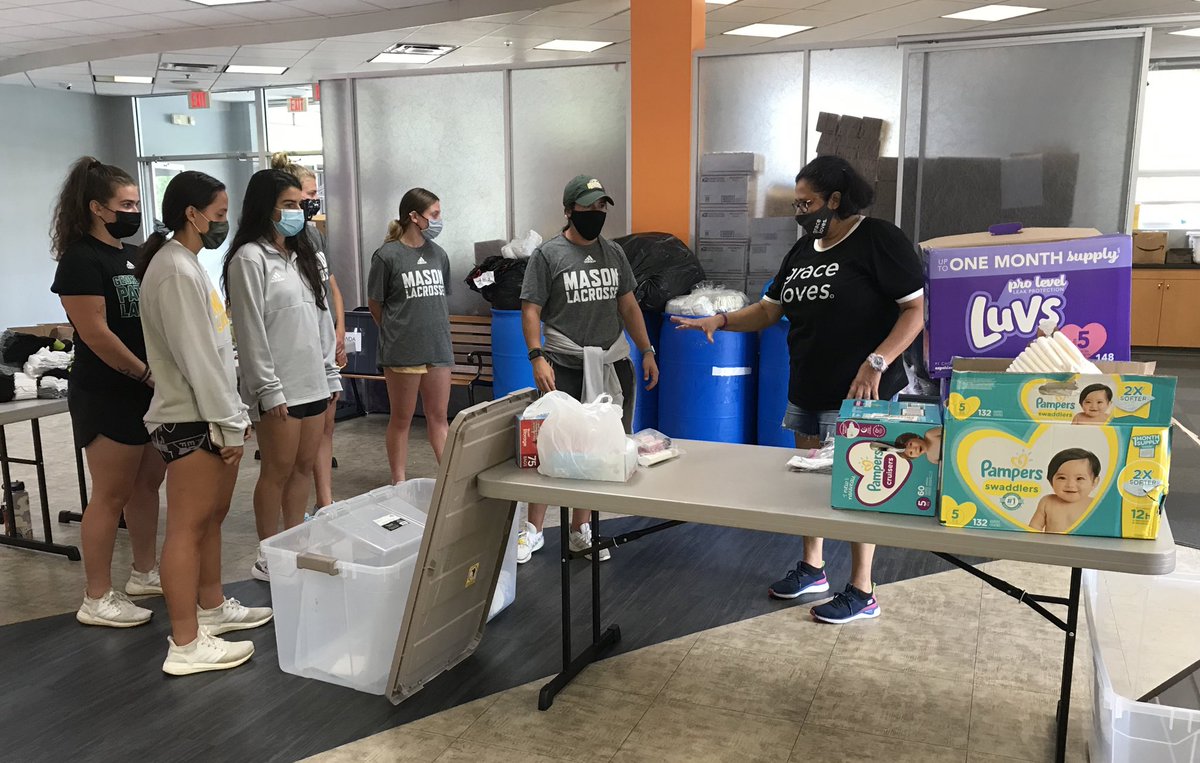 MNTNMVR_777's tweet photo. @GoMasonLax receiving instructions from @gracecov #GraceLoves outreach team on preparing care packages and items for distribution to local families in need. https://t.co/hpzoAIW6VU