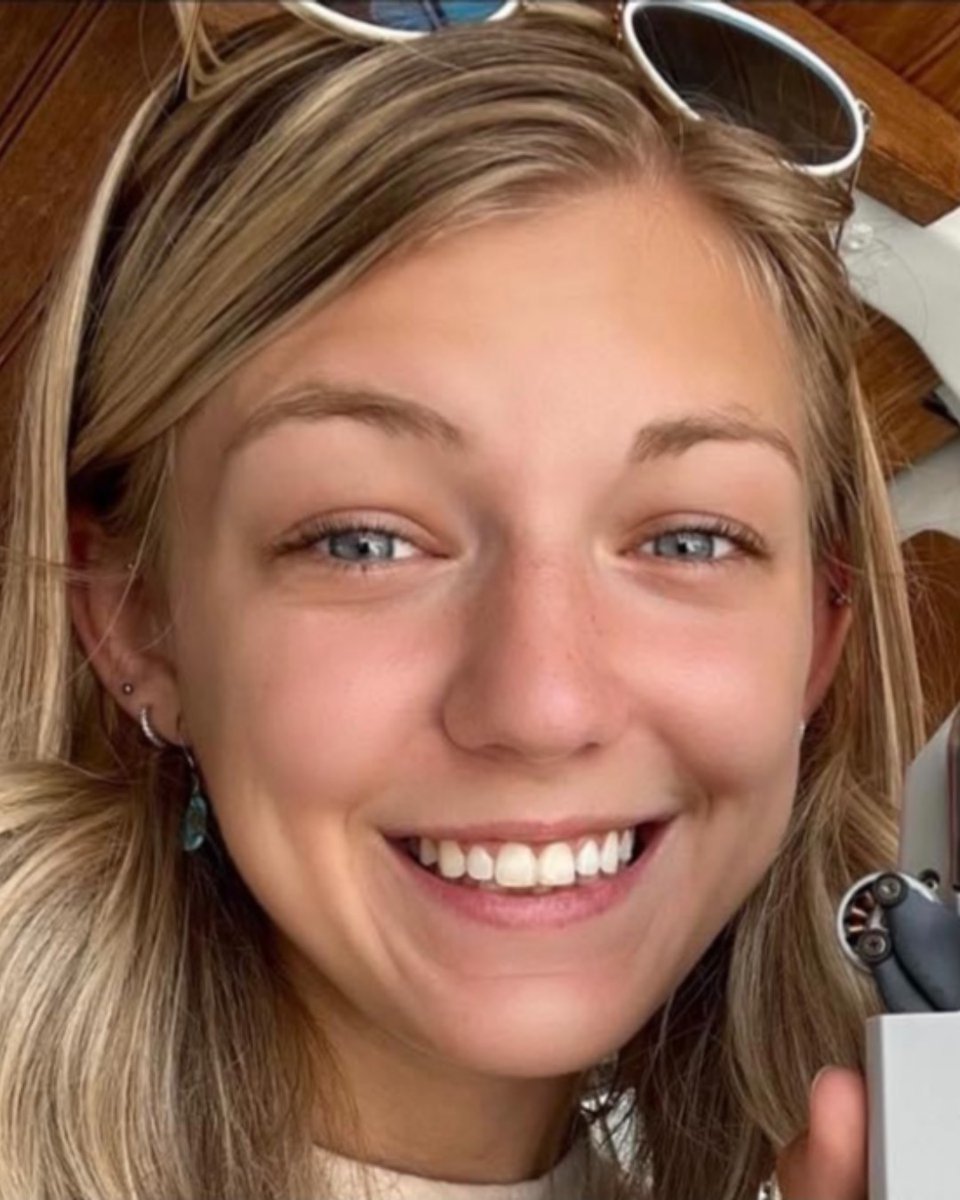A closeup photo of a young woman's face who is smiling