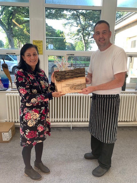 WHSSchool's tweet photo. Today Chandra Pankhania from the Soil Association, presented our Catering Manager, Ross Howarth with this beautiful award.  The award is to celebrate The William Henry Smith School achieving The Food For Life GOLD award for 10 consecutive years. https://t.co/Zahv7XnihQ
