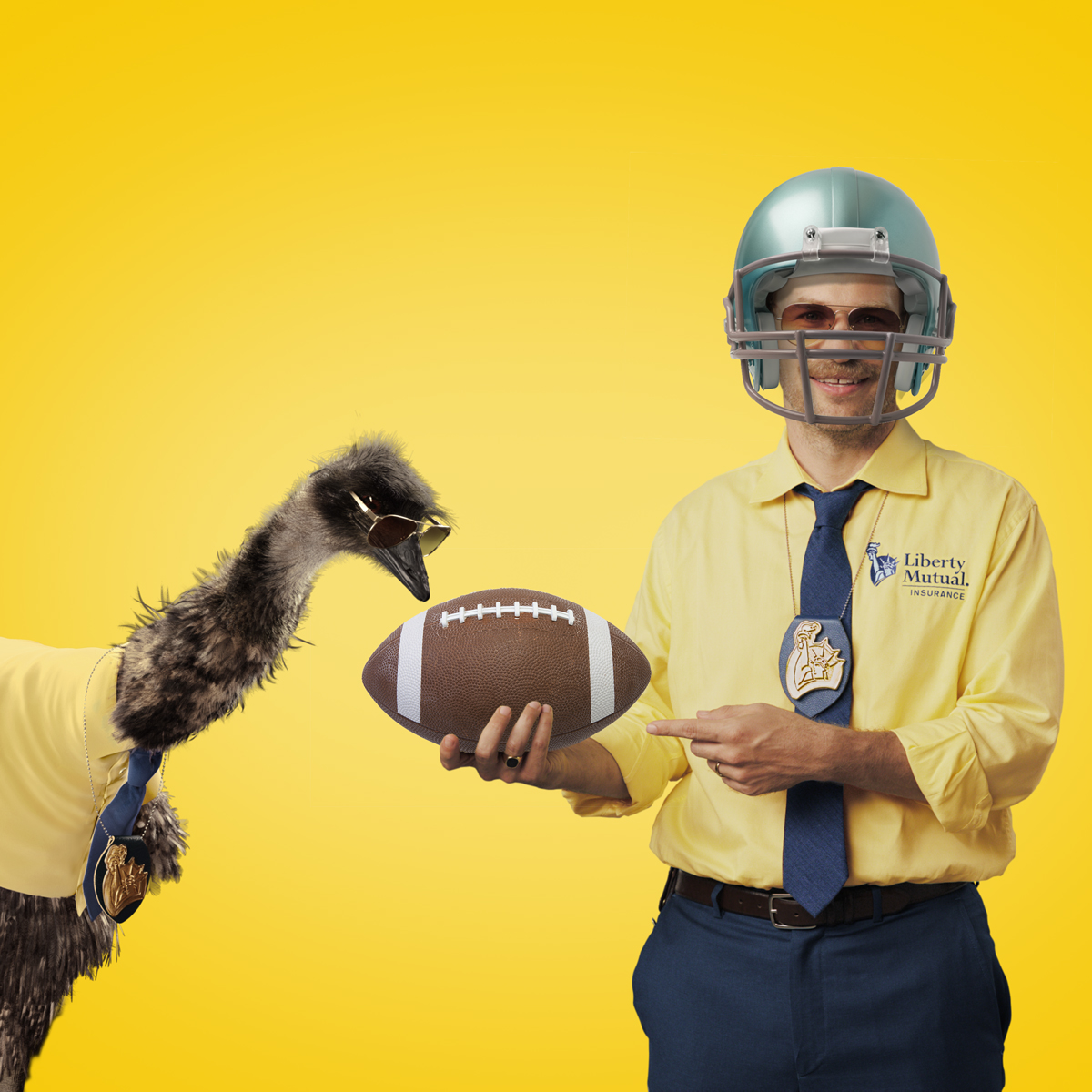 Doug is wearing a silver football helmet and holding a football, which LiMu is pecking