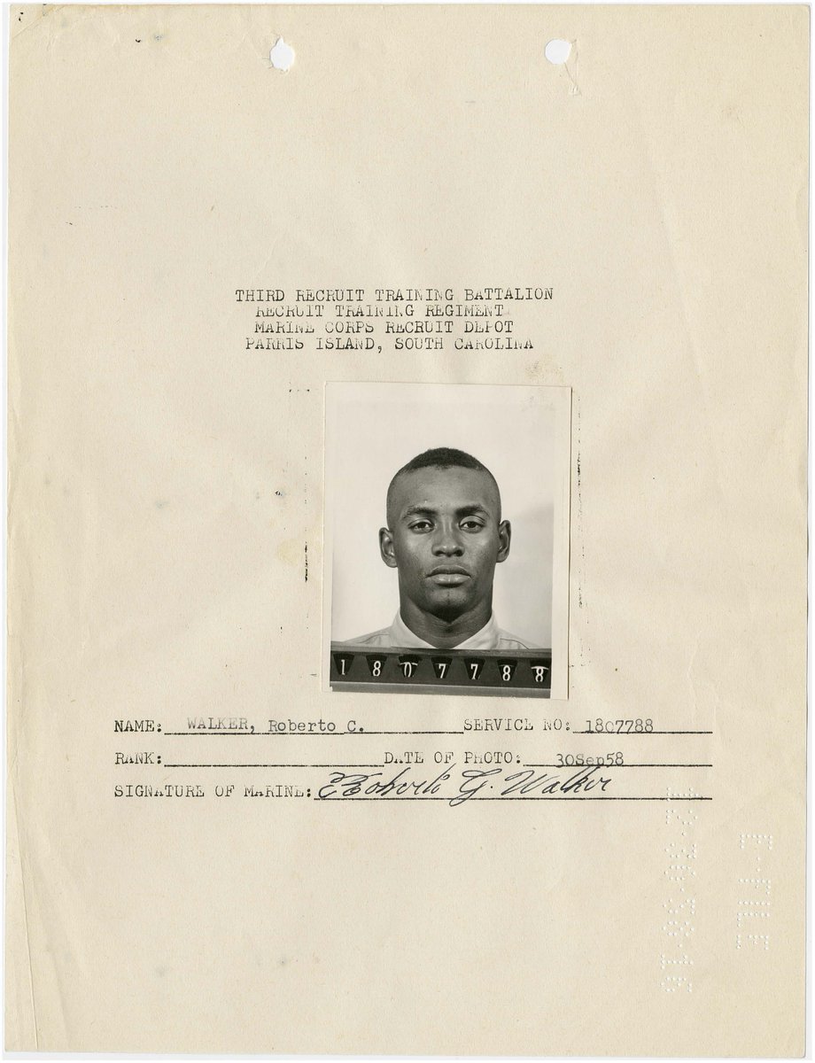 Black and white, tightly cropped photo of a man with a short haircut. Typed text is above the photo with his name and signature below