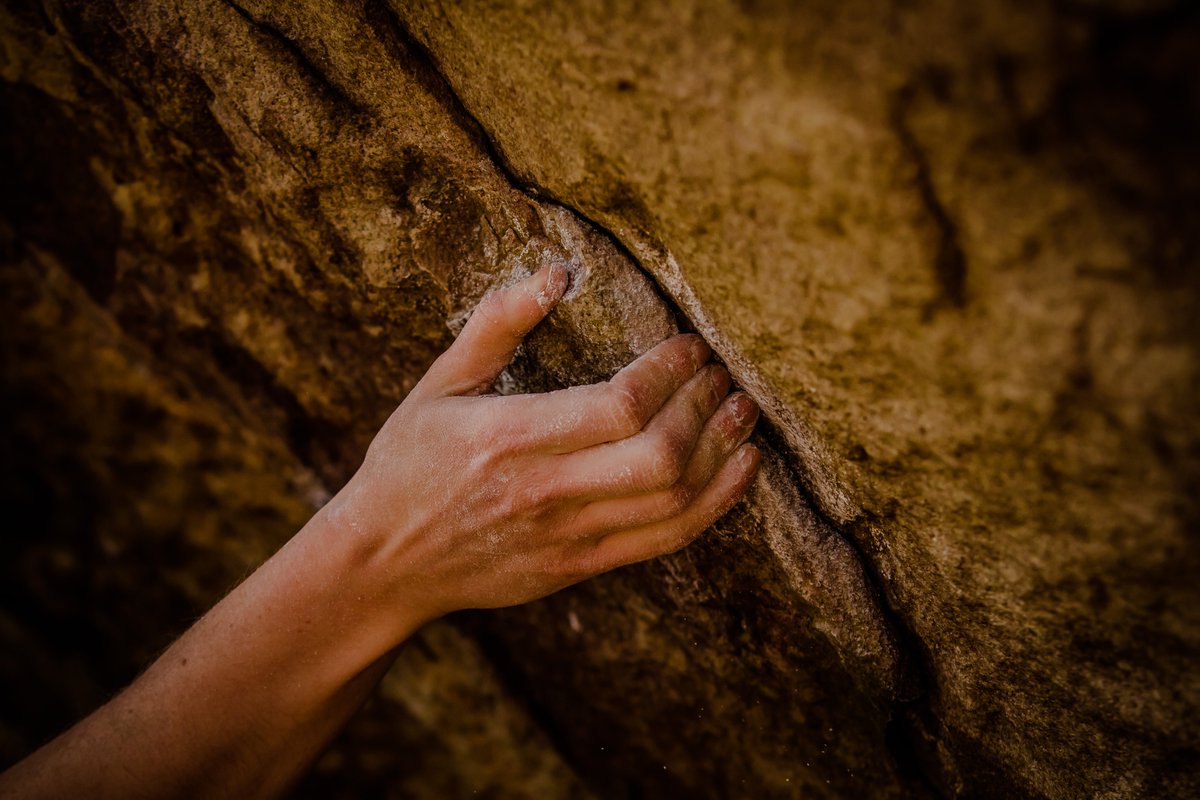 Bouldering, closeup of a hand in a crack. Picture by Arthur Hsu