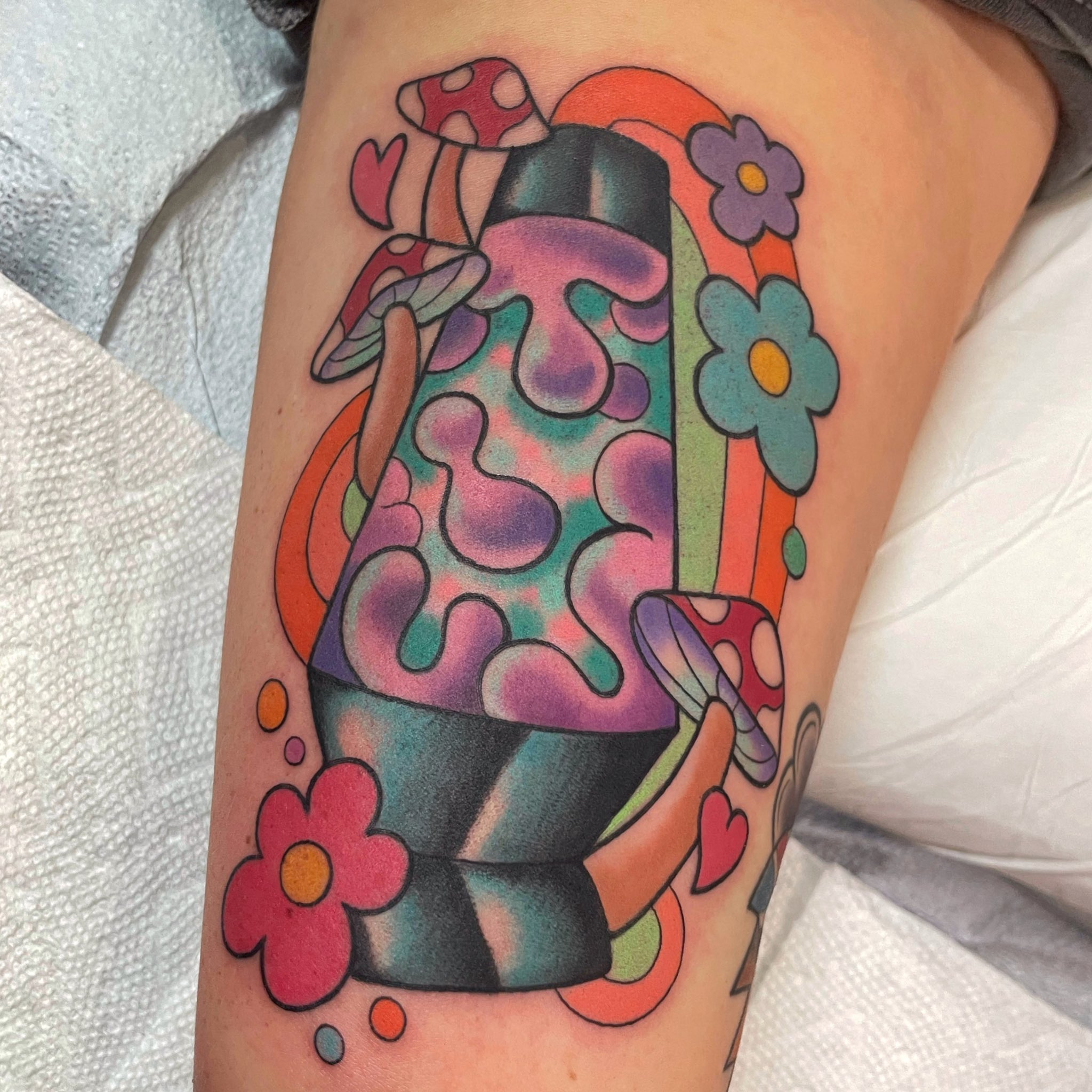 Genie lamp tattoo located on the wrist.