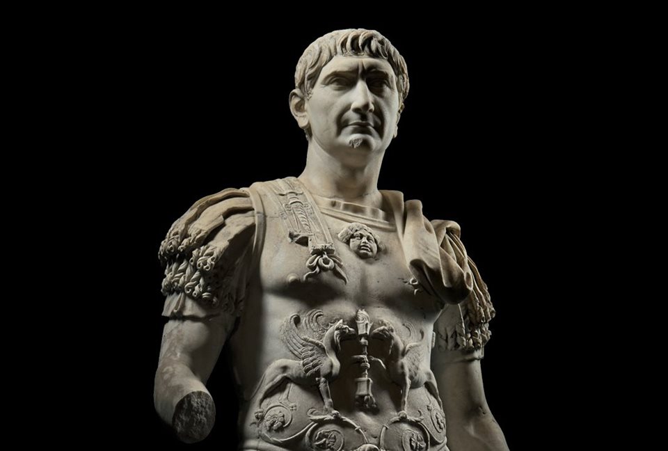 Ayer Cumplió 1968 años Trajano, emperador romano nacido en la Itálica sevillana, sepamos de él.
Trajano, hijo único, nació en una acomodada familia, su padre, Marcus, era administrativus y su madre, Marcia, dómina de casa aunque vendía tuppers de ánforas en reuniones caseras.