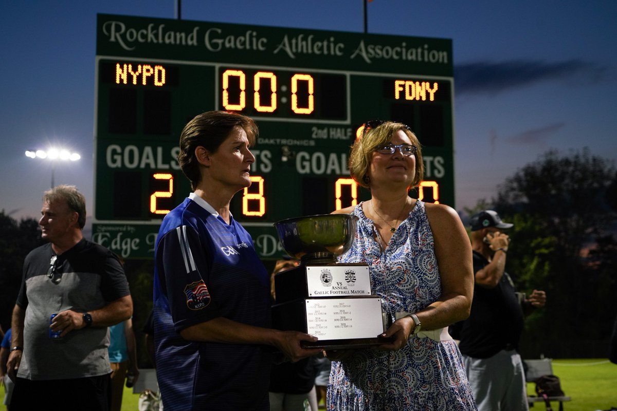 FDNY's tweet photo. The FDNY Gaelic Football Club played in the FDNY vs. @NYPDnews Gaelic Football Match. During the opening ceremony, a framed jersey was presented to the wife of Firefighter Dennis McHugh #Ladder13, a former player who was killed on September 11, 2001. #NeverForget https://t.co/cSI3uHXr8q