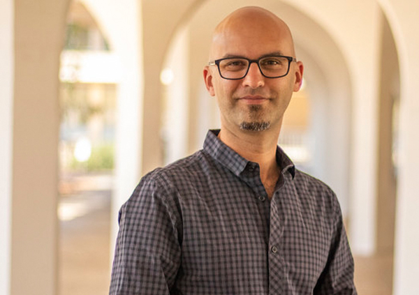 Photo of a white man with glasses in a building