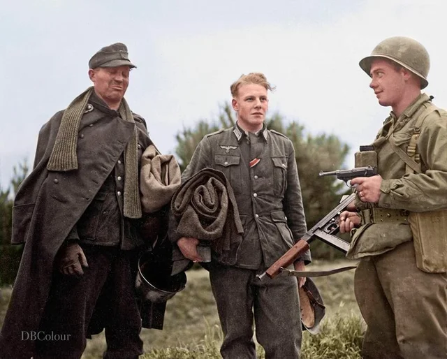Historybench's tweet image. Sergeant Maurice Parker from Fairfield, Maine, holds a German Lieutenant and his Sergeant at gun point after they were captured behind enemy lines. Anzio, Italy, April 14th, 1944.