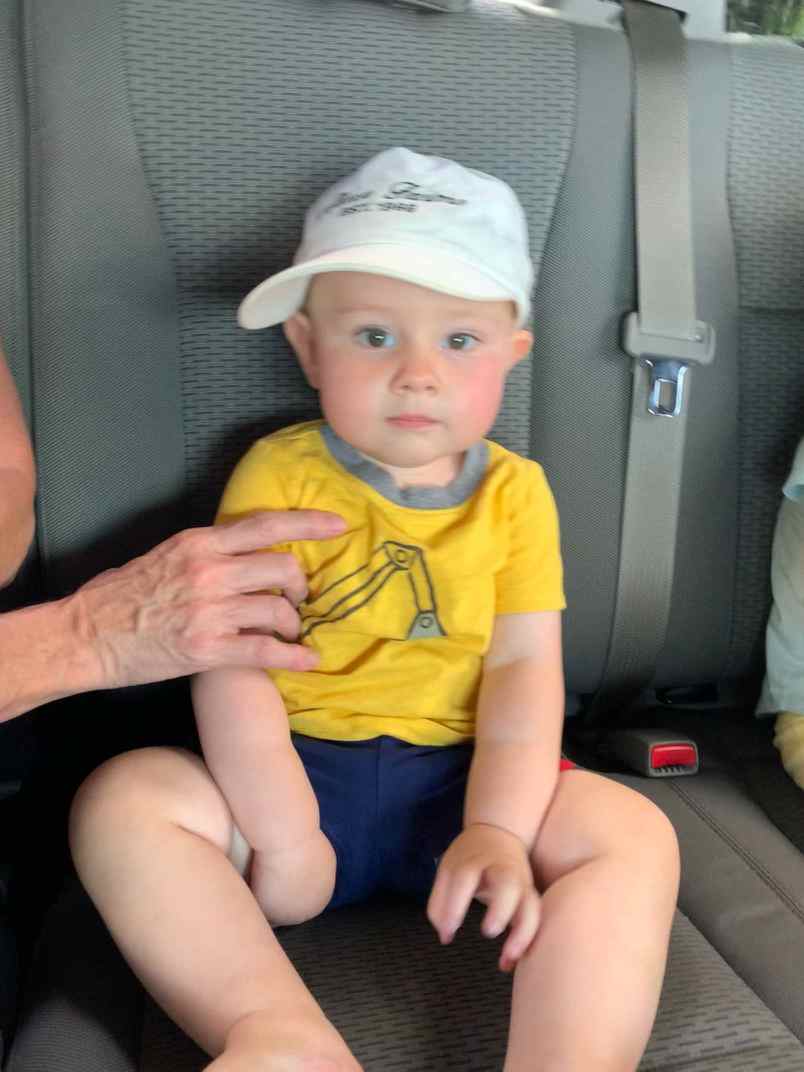 The boss came out to help check the heifers. You can tell he'll be a farmer... he never leaves home without his hat 🤠