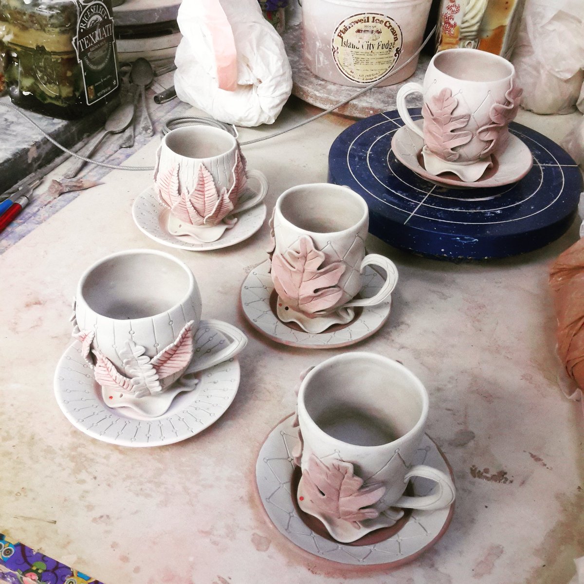 StasevichStudio's tweet photo. These have been done for a bit, and I'm kinda at the point in the studio where I'm bringing some clay back to workability, and destroying some things that just aren't worth going forward with. #teacup #cupandsaucer #pinchpots #oakleaf #cherryleaf #autumnleaves https://t.co/bztOZhiic2