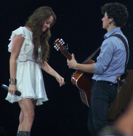 Miley Cyrus appeared as a surprise guest to perform “Before The Storm” with the Jonas Brothers at their concert in Dallas, TX on June 20, 2009.