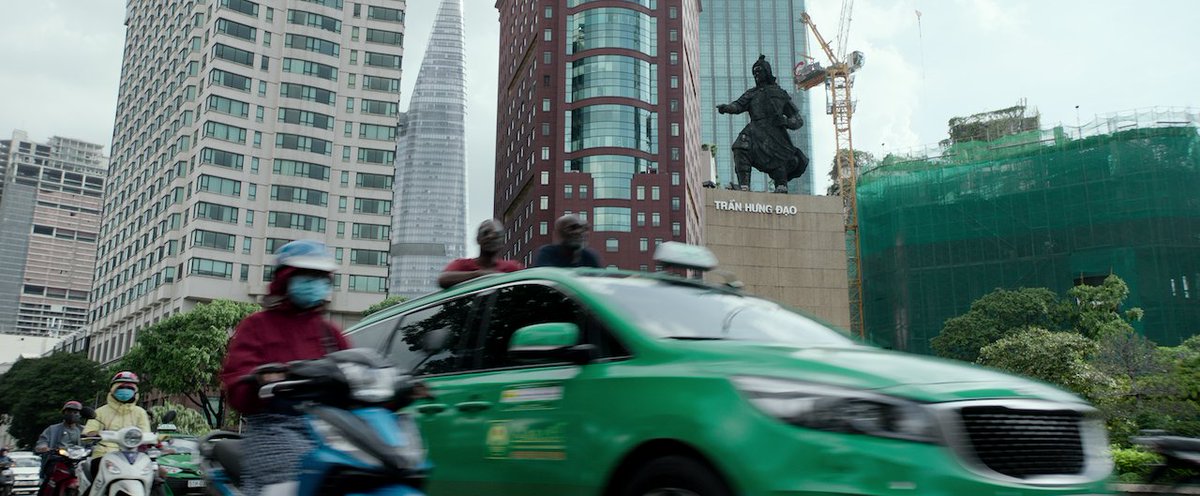 Finally, my most favorite shot is a blink-and-you-miss-it moment. Here Paul and Otis, enjoying the cityscape from a cab, pass by a statue of Trần Hưng Đạo, a legendary military leader in Vietnamese history. He fought off three Mongolian invasions during the 13th century.