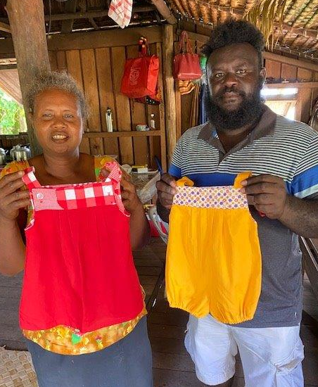 After the school visit, we located some of the local children. It was like a boxing day sale. Mothers and children appeared out of the bush very excited to be receiving beautiful clothes (and bags). (3/4)