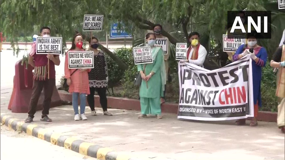 ANI's tweet photo. Delhi: Members of 'Voice of North East' protest against China at Teen Murti Chowk. A member says, "We warn China against their aggression in Indian territory. Chinese shouldn't think that we will remain silent because of our mere facial similarity." #GalwanValleyFaceOff https://t.co/DA5uVEIA7n