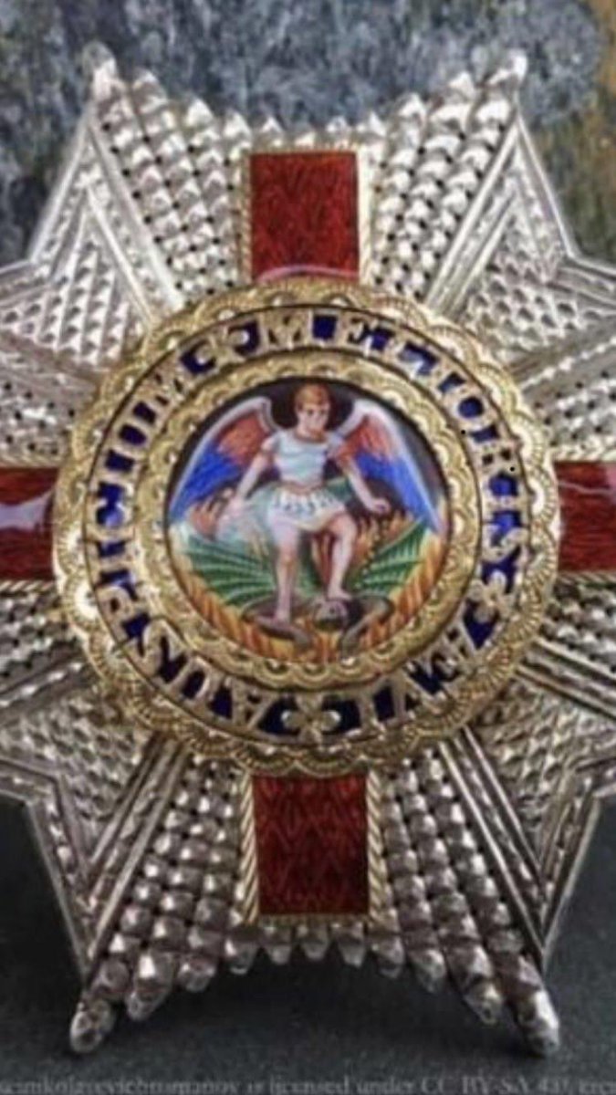 ThinkLeftOrg's tweet image. This is the KCMG medal. .Zoom into the image and you’ll see how/why the UK is built on racism.   Until these traditions etc are overhauled nothing will change..It shows a white angel, St Michael, stepping on the throat of a black demon (the devil). How is this still OK?