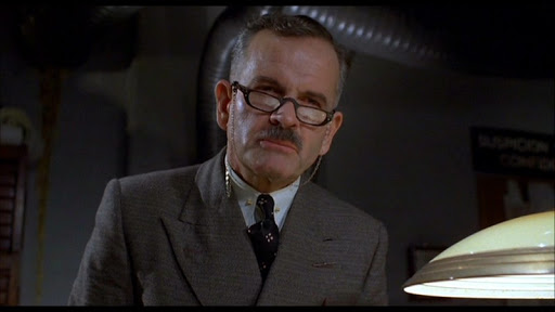 Then I went back in time to Brazil. Introduced to the wonderful world of Terry Gilliam by a friend, once again, surrounded by Michael Palin and Robert Di Niro, Holm stands out as Jonathan Pryce's Boss.