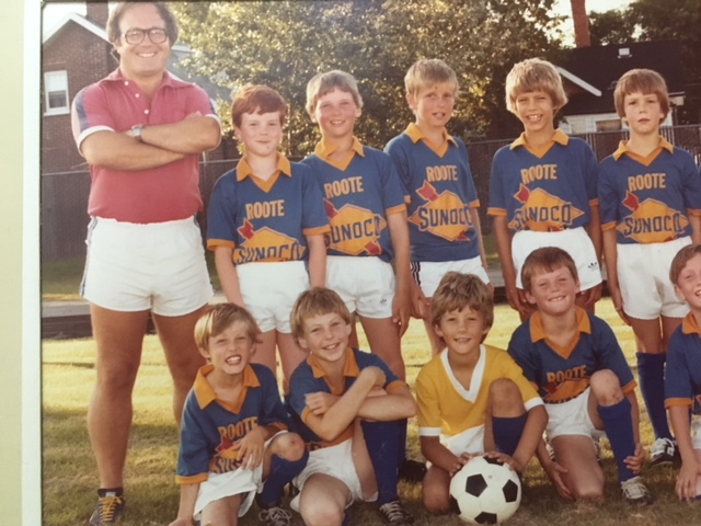 My dad was a very strong man. Rugby player. This is a picture from around then. I’m the goalkeeper. He’s the coach. Look at those legs in those short shorts. Magnificent pins.I saw that very strong man sit at a picnic table, put his head down on it, and weep.