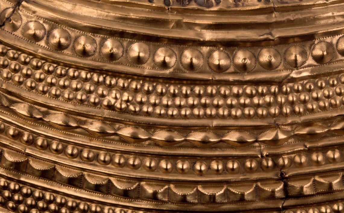 The intricately detailed object was beaten out of a single ingot of gold, requiring incredible skill.Decoration almost totally fills the object's surface.It's been suggested that the motif mimics multiple strings of beads and/or the folds of cloth.