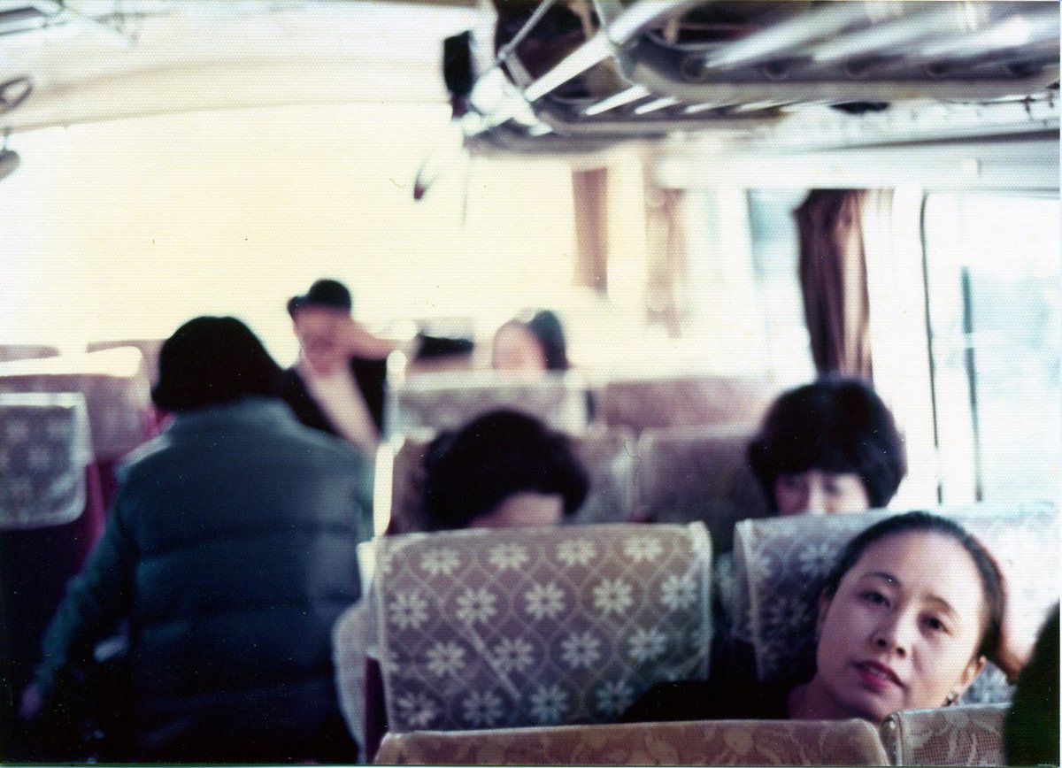 My heart is with Seisho Shirani and all of Chinami’s friends and comrades as day breaks on the 10th anniversary of her passing.[photo of Chinami on a bus in a window seat, leaning toward the window. Her hair is pulled back. She looks so cool.]