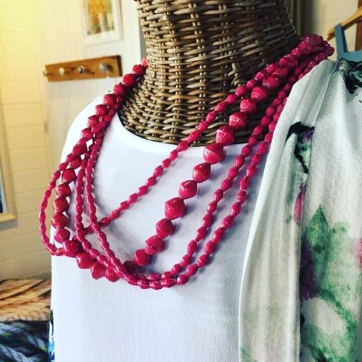 Pretty winter look with AfriBeads! Each bead is handcrafted by an artisan in Uganda. First paper is cut into triangles, then rolled into a bead. They are strung on wire and lacquered 3 times. Now ready to be created into a unique piece.Such incredible, intricate craftsmanship.