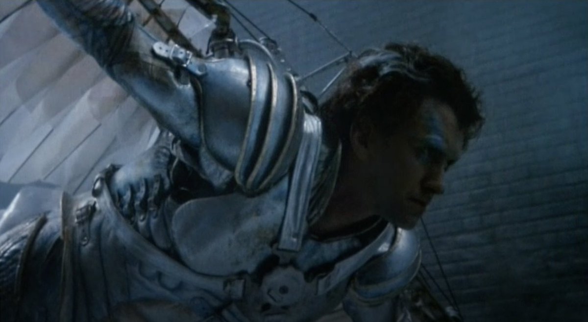 The tinest, most cutting in-film indictment of his dreamy character is the scene in which he is riding the weird tram-box home, drawing long, fantasy hair on his Jill print-out, going off into one of his weird reveries of chivalric-heroic rescue of the distressed damsel.