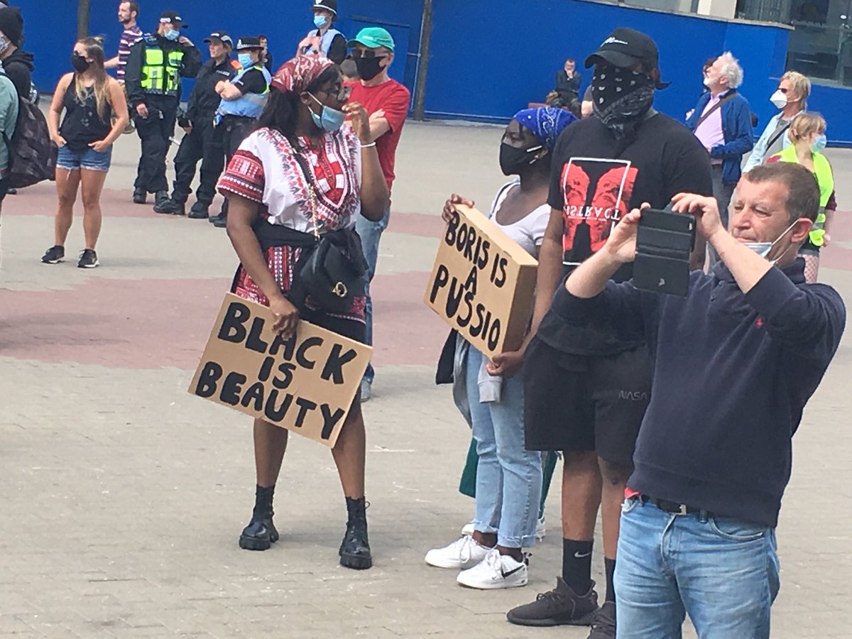 A ‘Black is Beauty’ plaque is brought to the #BLM protest