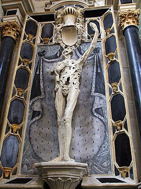 This is the Cadaver Tomb of René of Chalon in the church of Saint-Étienne in France. It belongs to the Prince of Orange who died age 25. He wanted his tomb to depict his rotting body as it would be 3 years after his death. Ar one time his heart was held in the figure's hand