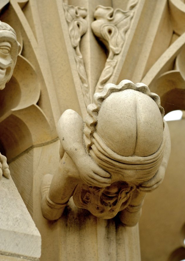 A series of 'Grotesque" carvings with Medieval ailment theme,at the base of the south east pinnacle in York Minster.