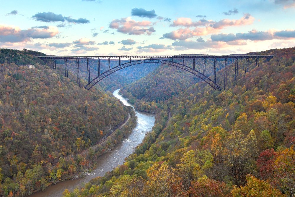 New River Gorge and bridge - Completed on 1977 and is the longest steel span in the western hemisphere and the third highest in the United States. Bridge Day is held here where BASE jumpers leap 876ft off the bridge. The New River is one of the oldest rivers on the continent.