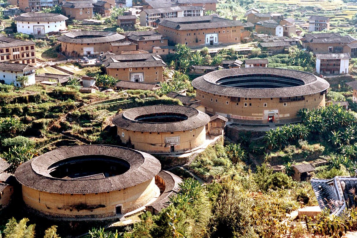In South China's Fujian province, Tulou (earth/mud building) architecture was followed by the Hakka people. They accommodated families of several generations like mini villages. They were closed outside and open inside.They came in symmetric shapes like round, oval and square.