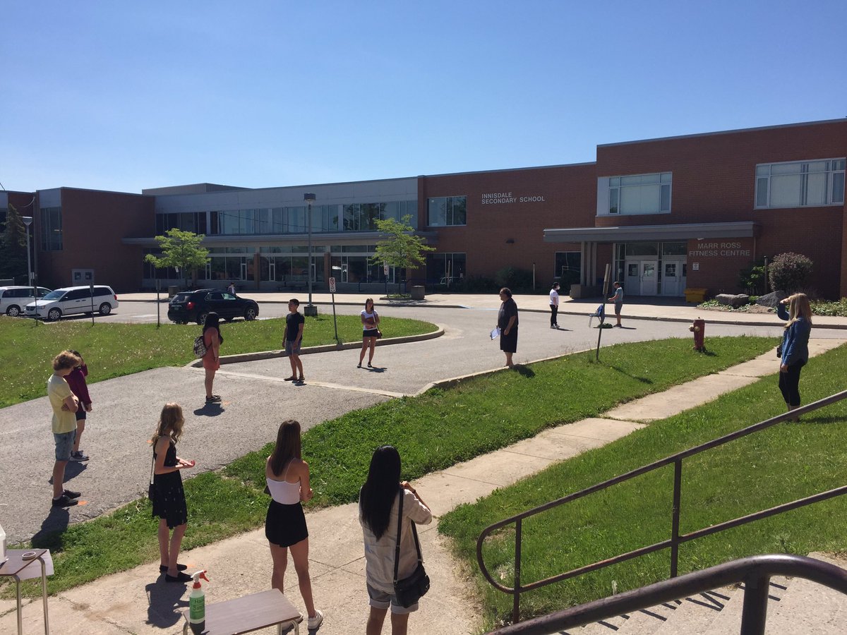 AReid_VP's tweet photo. The celebration of Innisdale’s grade 12 graduation has begun with safe social distancing in cap and gowns.  Congratulations graduates! @principalISS @SCDSB_Schools @deanmaltby https://t.co/ZfCi2iwzIY