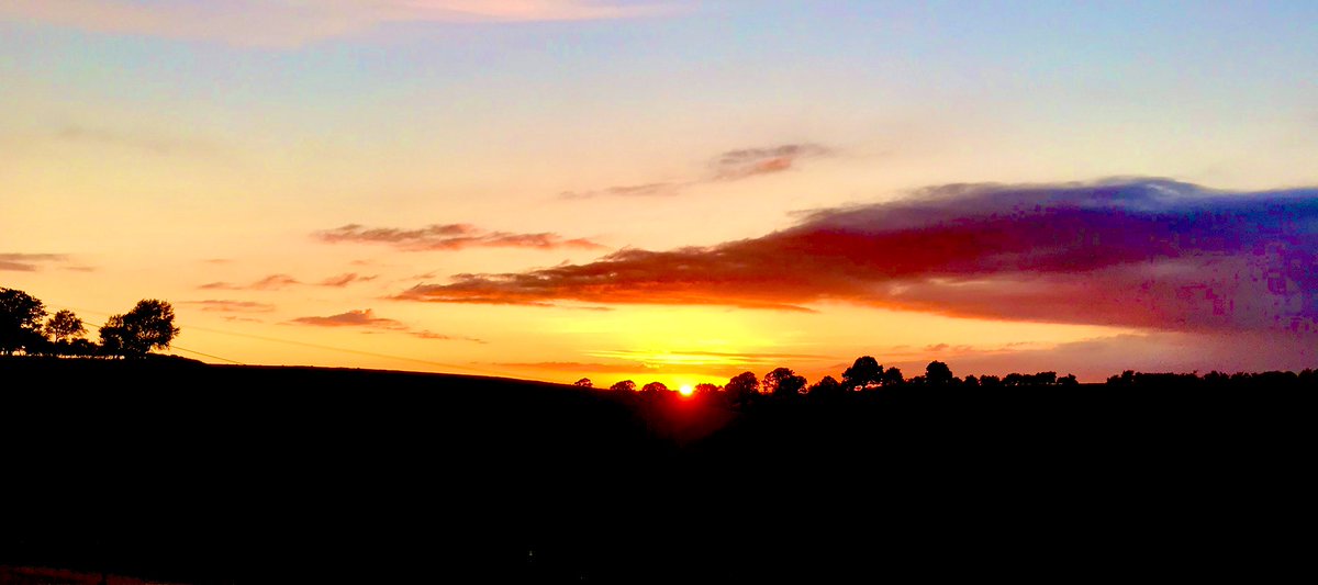 NHSAdrianO's tweet photo. In early June the sun sets neatly in the cleft of the hills.
#LockdownSunset https://t.co/aQJuBcFLIq