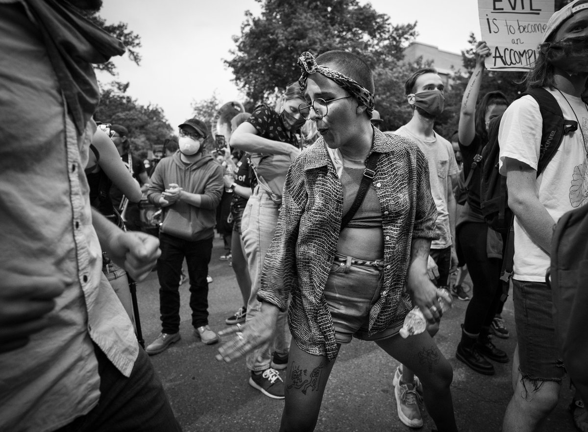 glasspilgrim's tweet photo. A marcher jamming to a live brass band tune. #denverprotests https://t.co/gSloTfdpsU