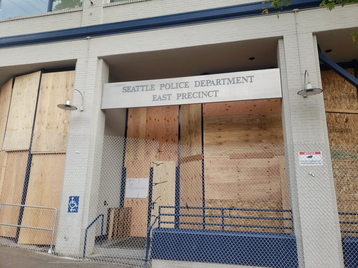 AllegedlyTommy's tweet photo. A surreal sight at the Seattle Police departments east precinct. A warzone yesterday, boarded up and abandoned today. #seattleprotest #seattleprotests https://t.co/7dH3DStZkc