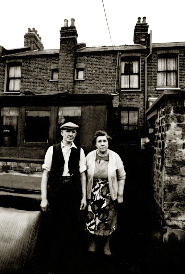 The window on the top right of this photograph was John Claridge’s former bedroom when he took this portrait of his neighbours in Plaistow – Mr & Mrs Jones – in 1968, on a visit home in his early twenties.