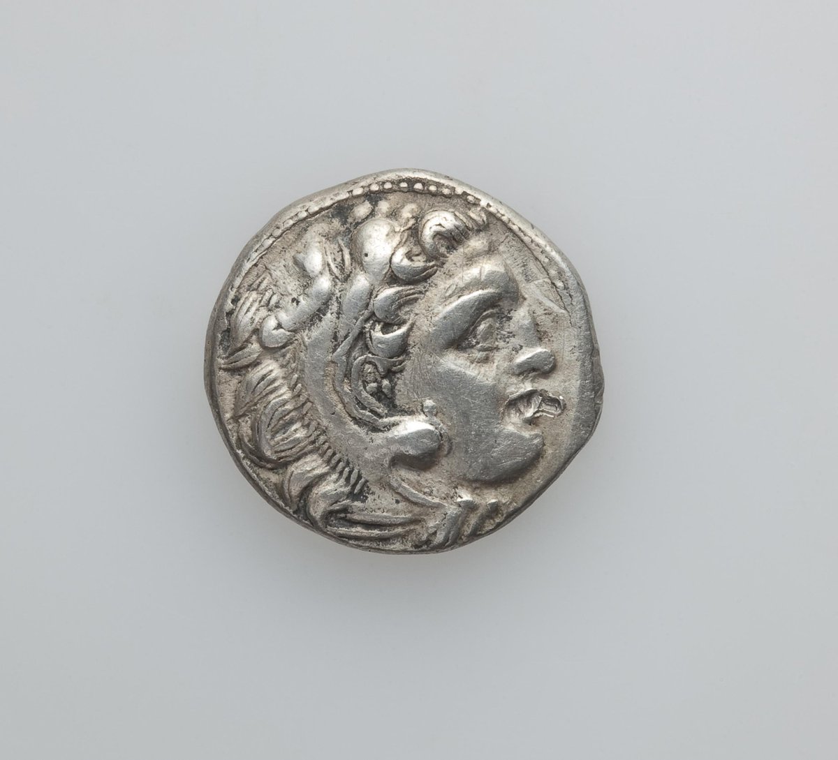 A Drachma, showing the head of Alexander the Great 336-323s BC who died on this day in 323BC From the numismatic department of the State Hermitage Museum #hermitageuk #hermitagemuseum #numismatics