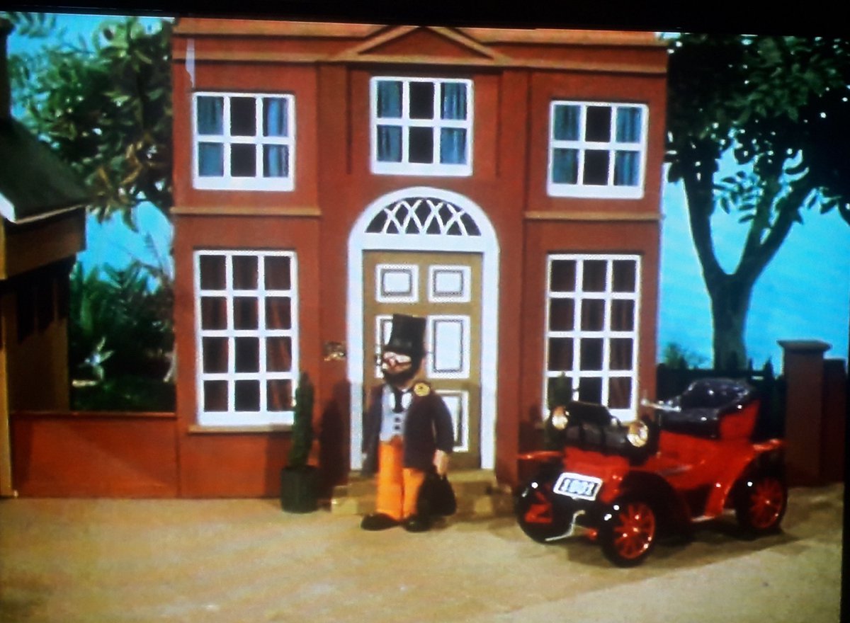 Dr. Mopp's Residential Surgery. A large Edwardian townhouse that chimes with his appearance and car, but is very out of step with the other buildings on the Village Green.