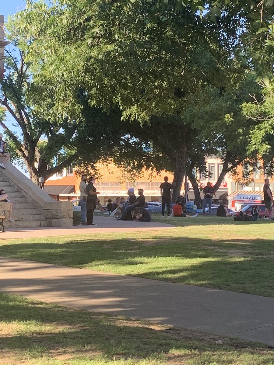 authorDomW's tweet photo. My name is Dominique Weaver and I will be covering the Denton protest tonight for @Central_Track about 15 minutes before it’s set to begin and already people are scattered under the shade near the courthouse on the square #dentonprotests https://t.co/G0BWlIQO32