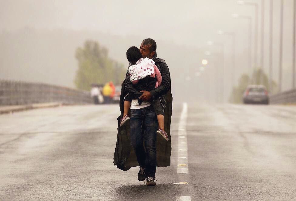 wissam_shabat's tweet photo. A Syrian refugee kisses his son as he walks through a rainstorm towards Greece's border with Macedonia, near the Greek village of Idomeni.

- Yannis Behrakis https://t.co/m4YrO8yWTc